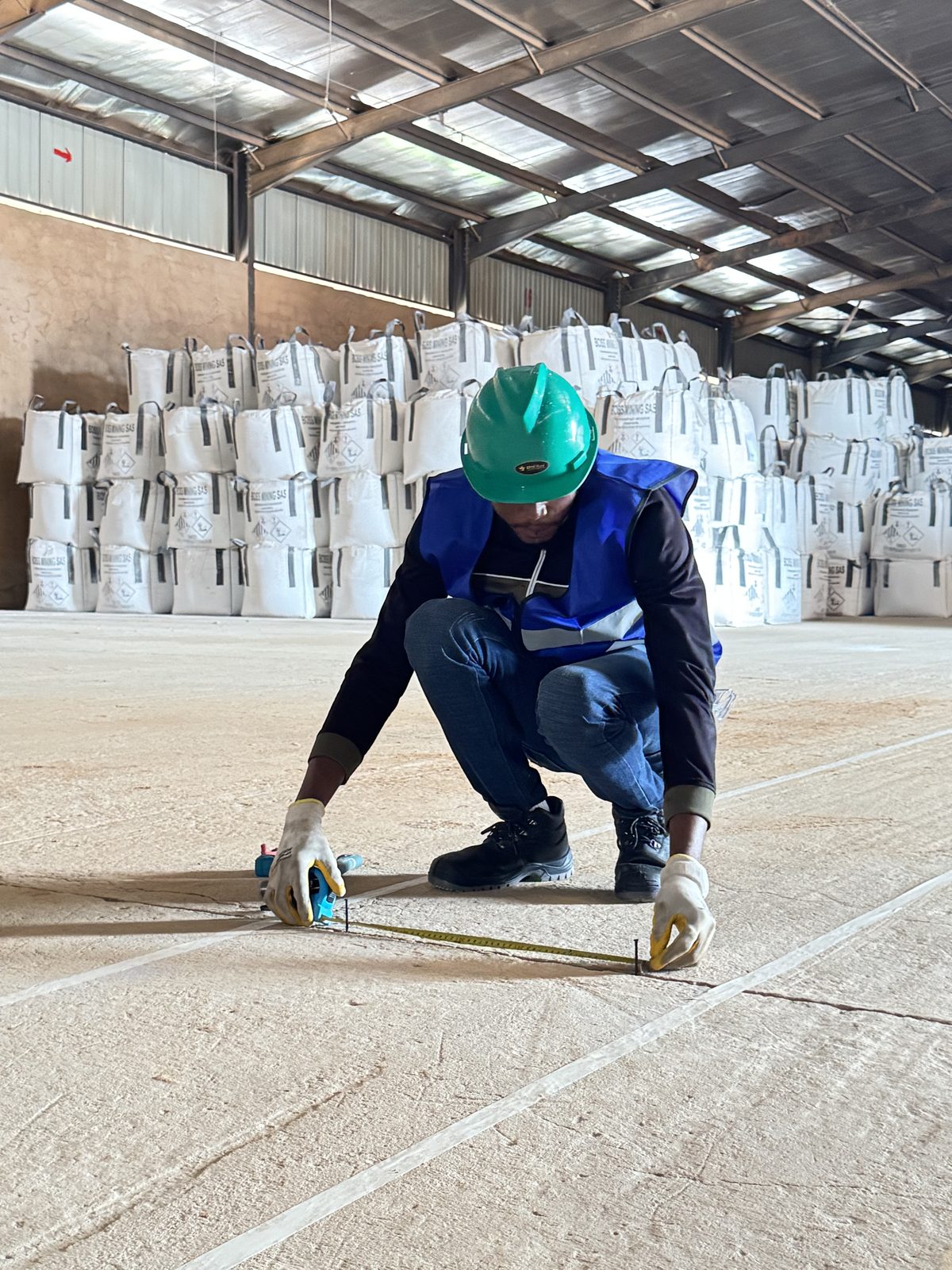 Ubuntu Groupe construction crew measuring warehouse layout at a mining site in Kolwezi, DRC